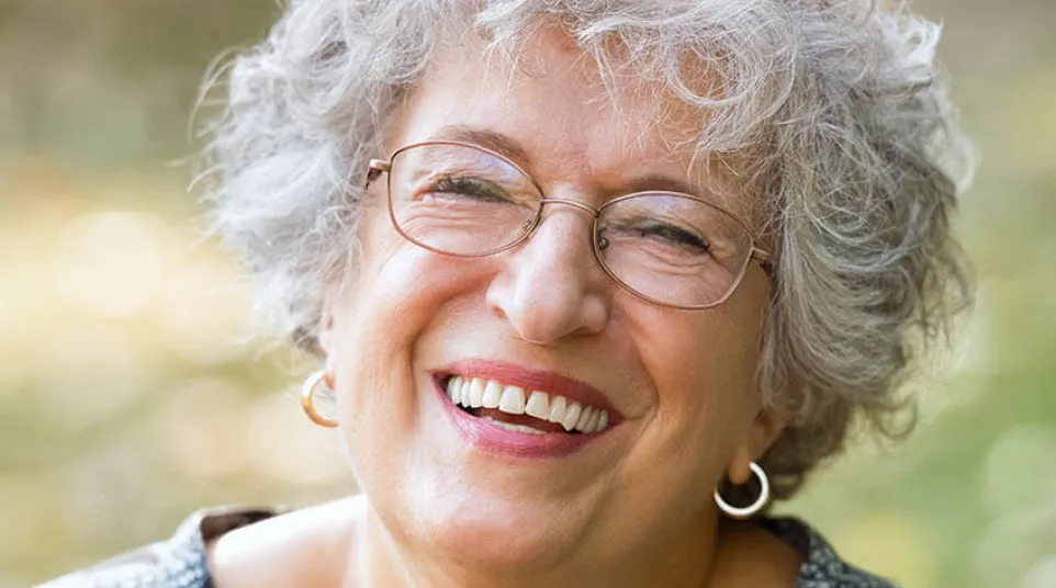 a person with glasses smiling